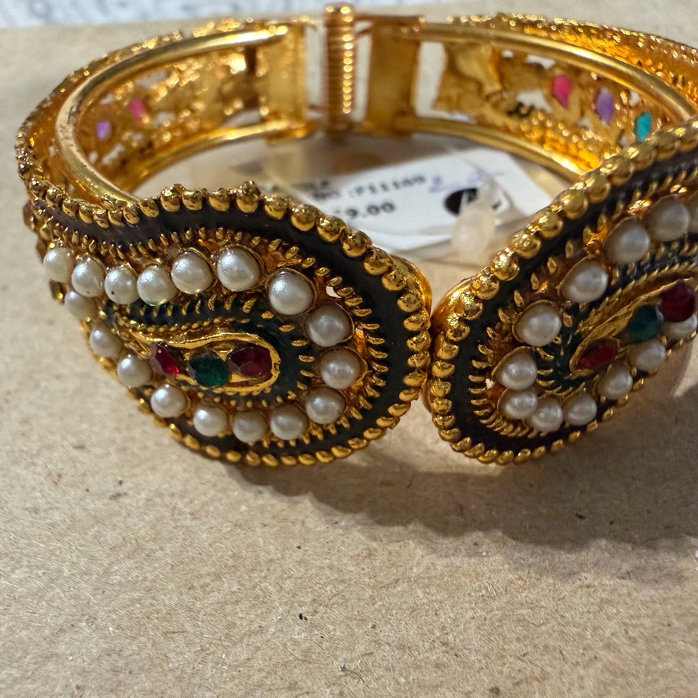 Elegant Gold and Multicolor Beaded Bracelet opens closes at one end .